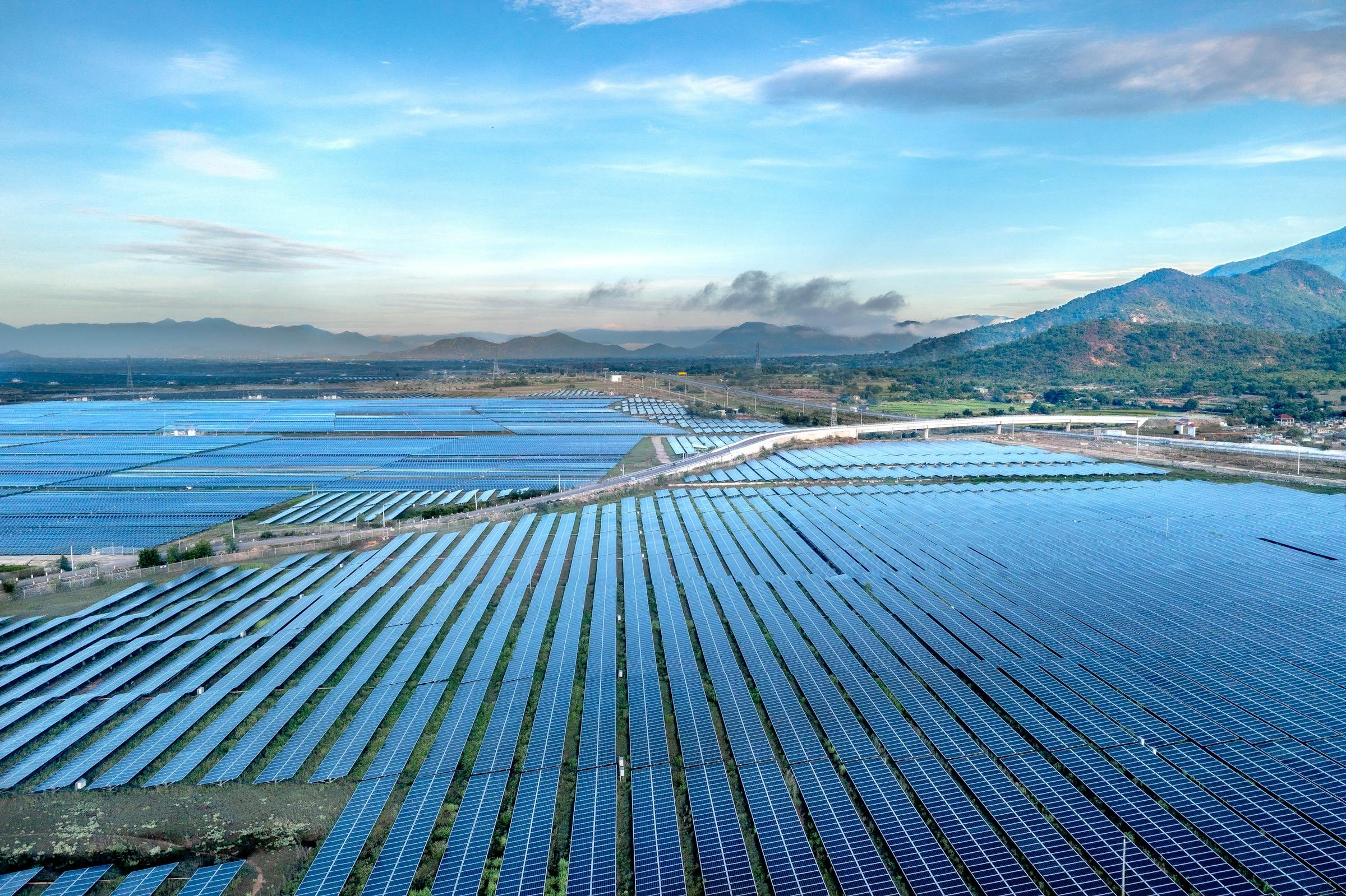 Expansive aerial view of a utility scale solar farm at sunrise