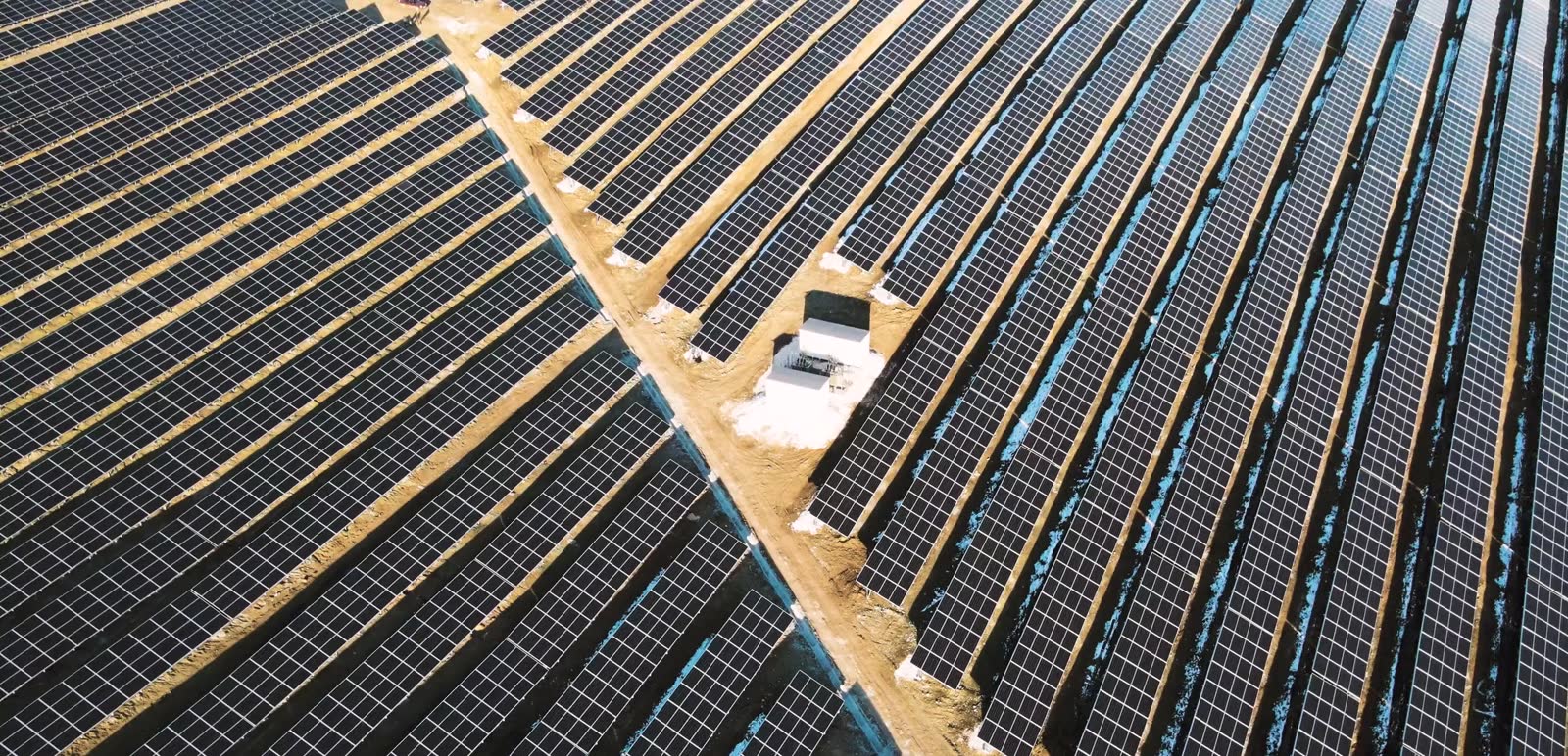 Aerial view of a large scale solar farm at golden hour