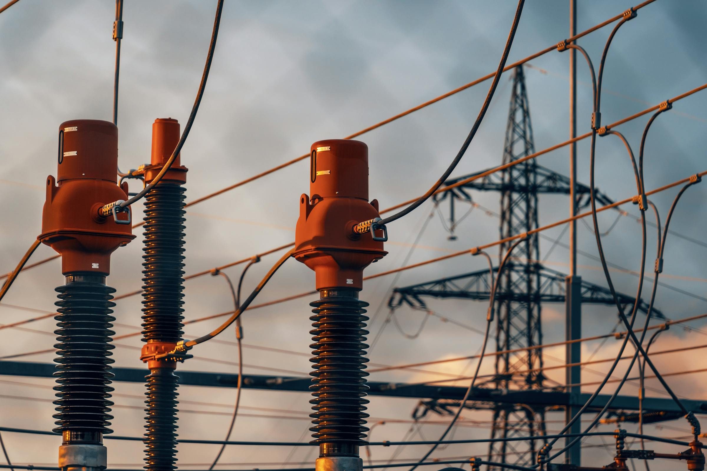 Power transmission infrastructure against a sunset sky