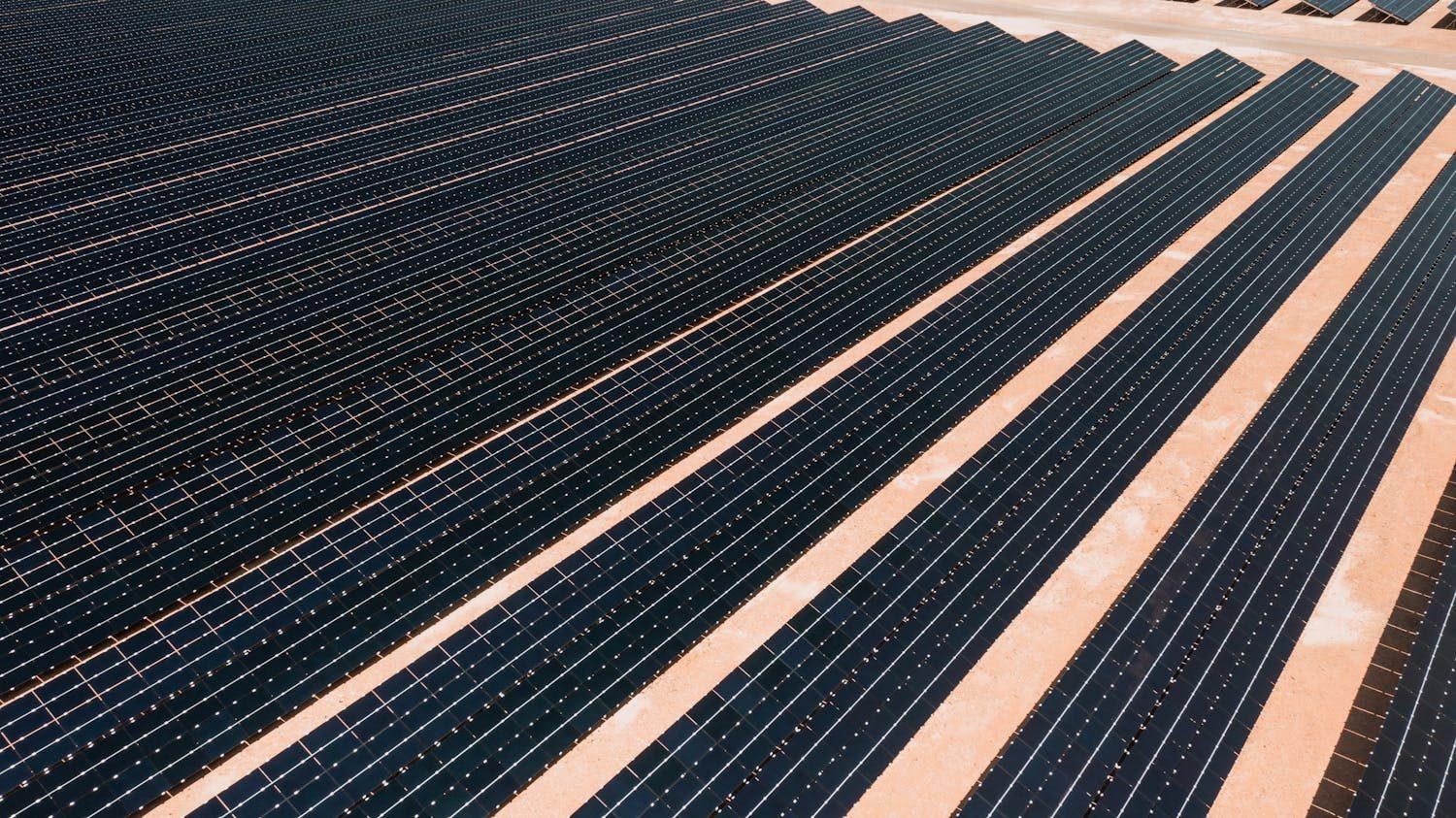Aerial view of precisely aligned rows of solar panels